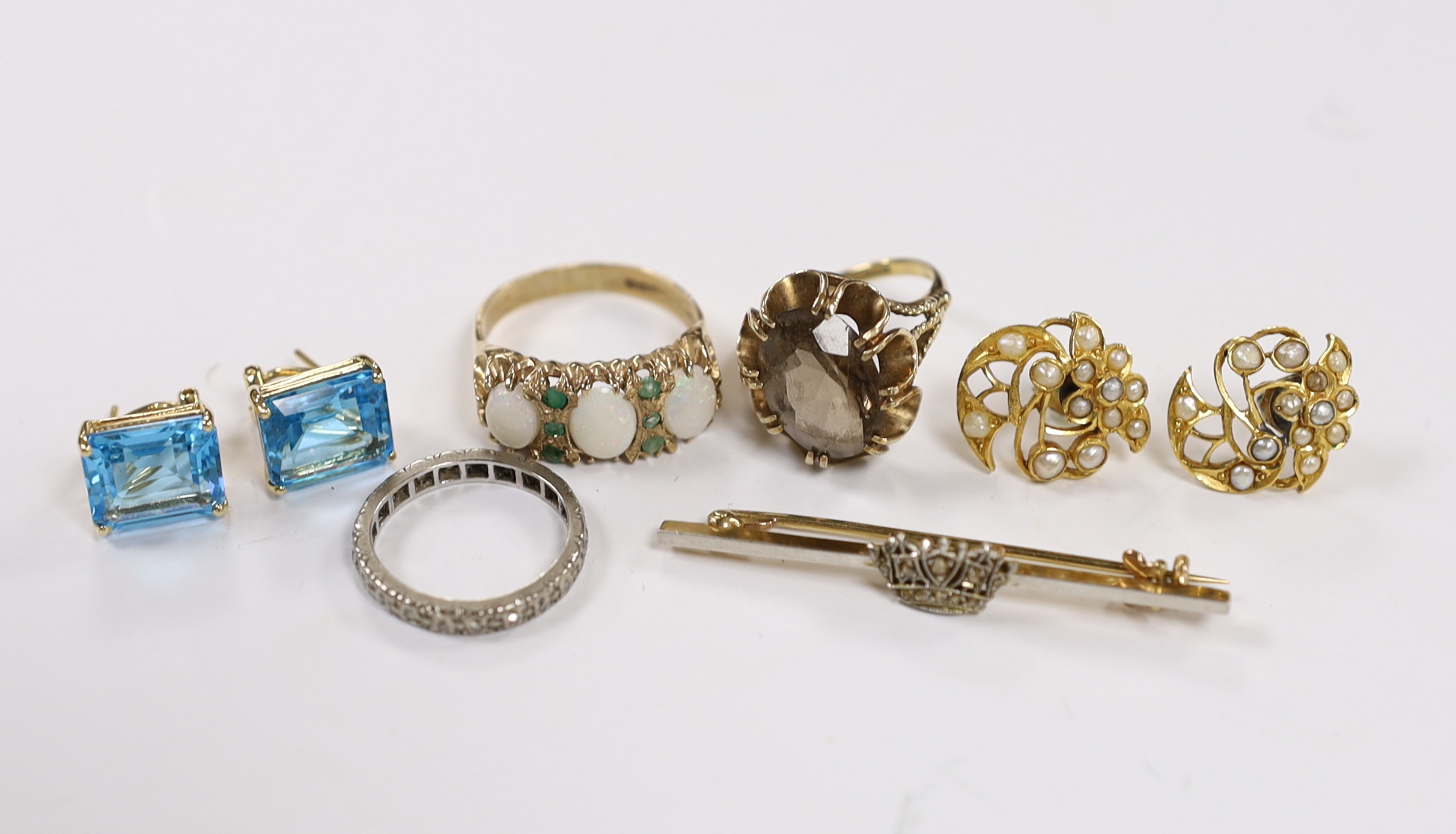 Assorted jewellery including a modern pair of 14k and blue topaz earrings, a pair of 375 and seed pearl cluster earrings, two 9ct gold and gem set rings including a white opal and emerald chip, a white metal and diamond